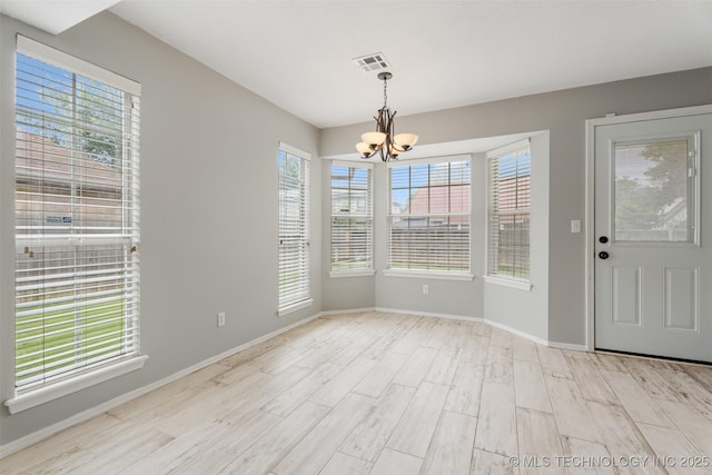 1802 S Fir Pl, Broken Arrow, OK 74012 - unfurnished dining area with a chandelier, wood finished floors, healthy amount of natural light, and baseboards