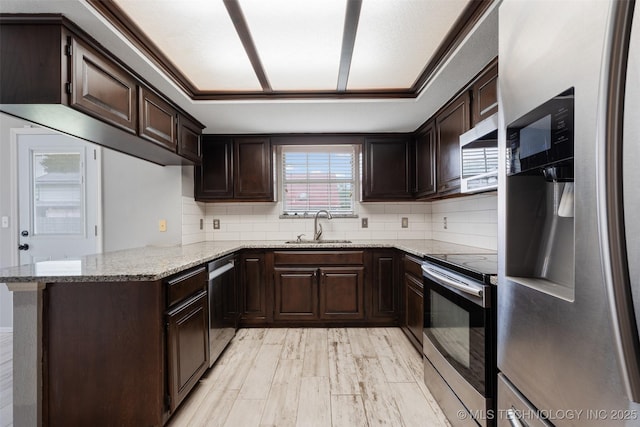 1802 S Fir Pl, Broken Arrow, OK 74012 - kitchen with appliances with stainless steel finishes, a sink, light stone counters, and dark brown cabinetry