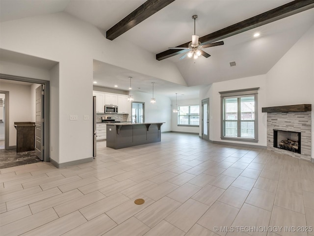 17710 E 45th Pl S, Tulsa, OK 74134 - unfurnished living room featuring ceiling fan, a fireplace, baseboards, beam ceiling, and recessed lighting