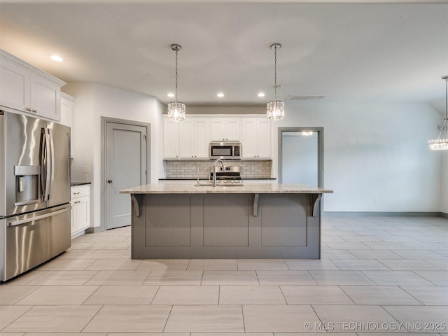 17710 E 45th Pl S, Tulsa, OK 74134 - kitchen featuring appliances with stainless steel finishes, a sink, backsplash, white cabinetry, and light stone countertops