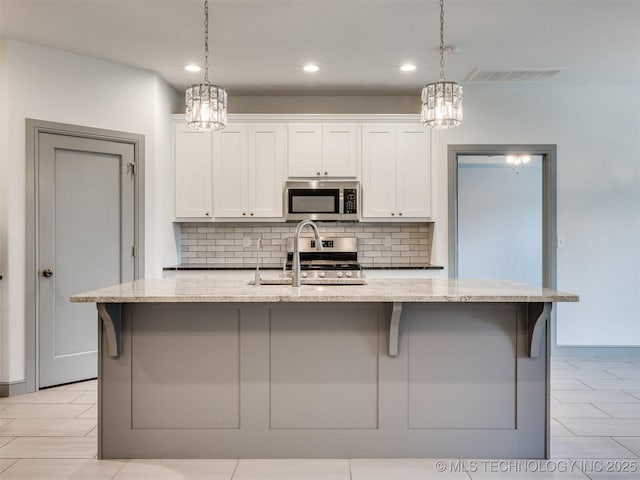 17710 E 45th Pl S, Tulsa, OK 74134 - kitchen featuring appliances with stainless steel finishes, a chandelier, decorative backsplash, white cabinetry, and recessed lighting