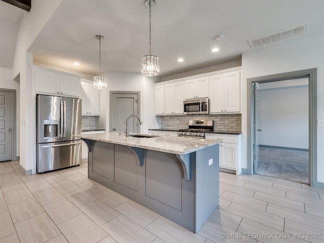 17710 E 45th Pl S, Tulsa, OK 74134 - kitchen featuring appliances with stainless steel finishes, a sink, recessed lighting, a kitchen breakfast bar, and backsplash