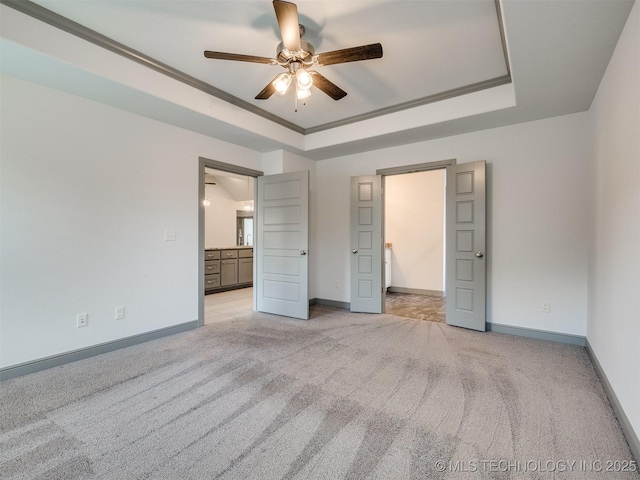 17710 E 45th Pl S, Tulsa, OK 74134 - unfurnished bedroom with light carpet, baseboards, a raised ceiling, ensuite bathroom, and ceiling fan
