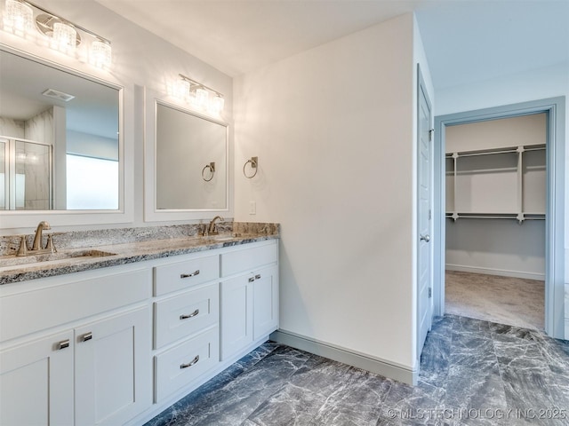 17710 E 45th Pl S, Tulsa, OK 74134 - full bath featuring double vanity, a spacious closet, a shower stall, and baseboards