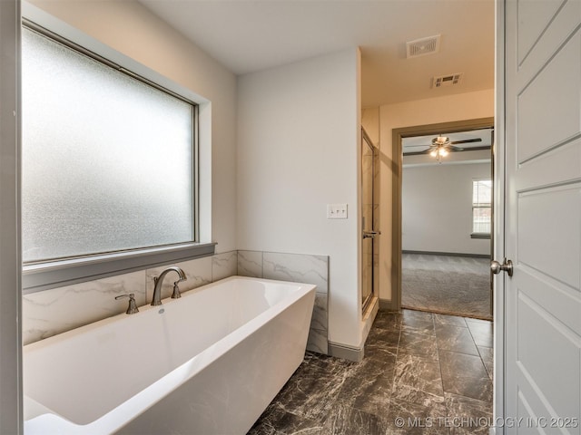17710 E 45th Pl S, Tulsa, OK 74134 - full bath featuring a freestanding tub, a shower stall, marble finish floors, and baseboards