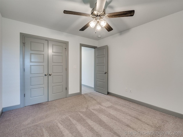 17710 E 45th Pl S, Tulsa, OK 74134 - unfurnished bedroom featuring carpet flooring, baseboards, a ceiling fan, and a closet