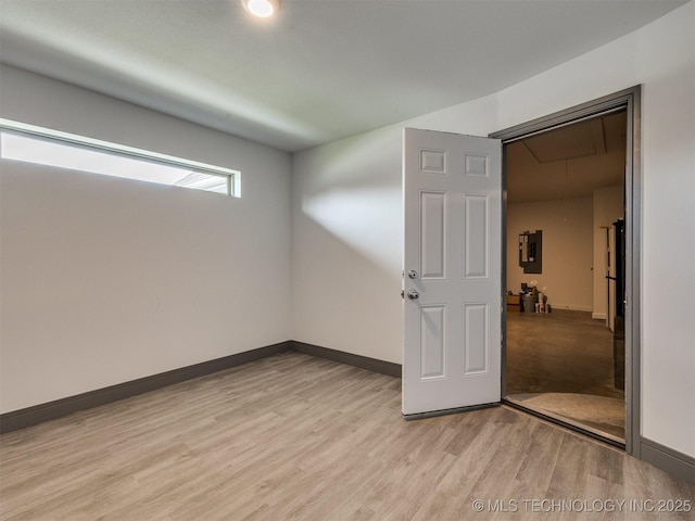 17710 E 45th Pl S, Tulsa, OK 74134 - empty room with attic access, light wood-type flooring, baseboards, and electric panel
