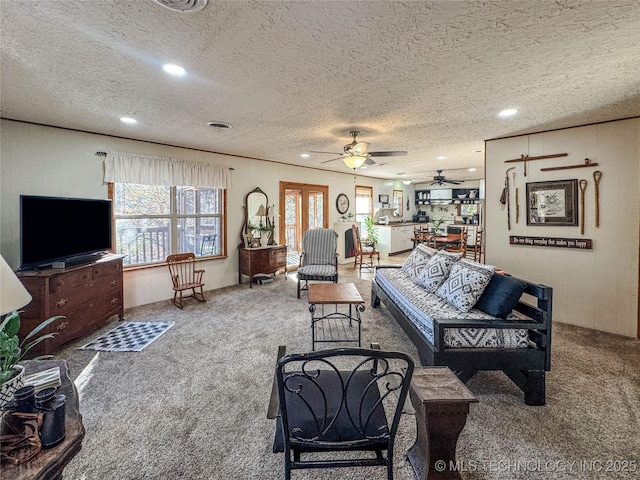 2064 Cave Creek Ct, Kansas, OK 74347 - carpeted living room with a textured ceiling, a ceiling fan, healthy amount of natural light, recessed lighting, and wooden walls