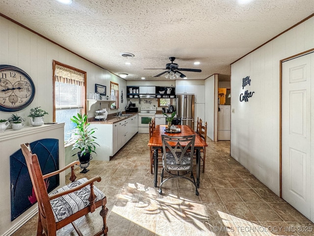 2064 Cave Creek Ct, Kansas, OK 74347 - dining area with a ceiling fan, crown molding, wood walls, recessed lighting, and a textured ceiling