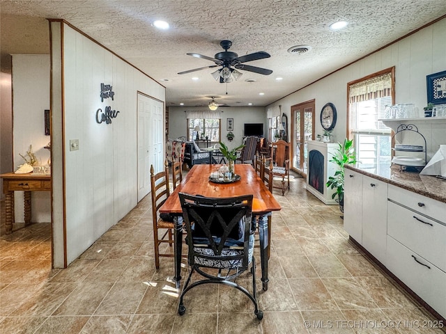 2064 Cave Creek Ct, Kansas, OK 74347 - dining space featuring a ceiling fan, ornamental molding, wooden walls, and recessed lighting
