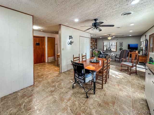 2064 Cave Creek Ct, Kansas, OK 74347 - dining area with ceiling fan, wooden walls, recessed lighting, and a textured ceiling