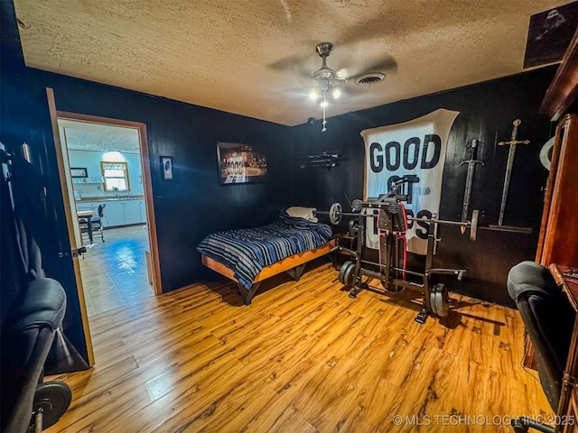 2064 Cave Creek Ct, Kansas, OK 74347 - bedroom with wood finished floors, a textured ceiling, and ceiling fan