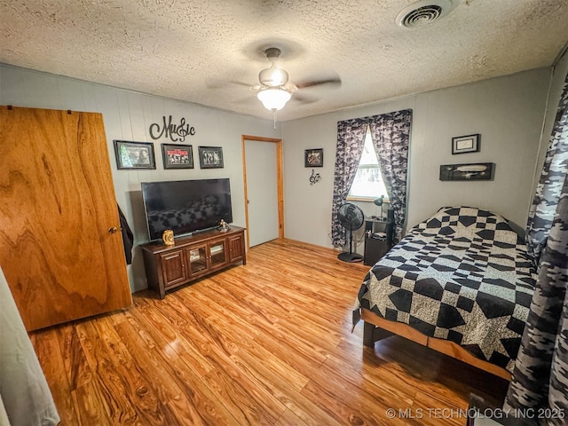 2064 Cave Creek Ct, Kansas, OK 74347 - bedroom with light wood-style floors, a textured ceiling, and ceiling fan
