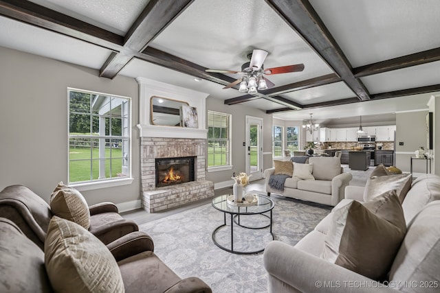 8602 S 91st E Ave, Tulsa, OK 74133 - living area featuring coffered ceiling, a chandelier, plenty of natural light, ceiling fan, and beam ceiling