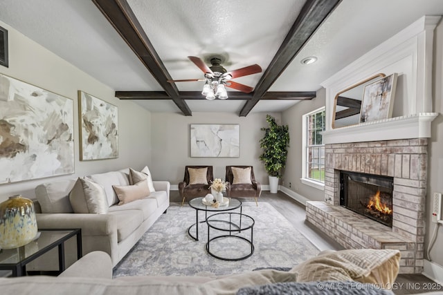 8602 S 91st E Ave, Tulsa, OK 74133 - living room with a fireplace, beamed ceiling, ceiling fan, wood finished floors, and coffered ceiling