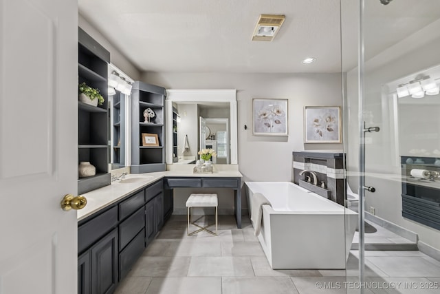 8602 S 91st E Ave, Tulsa, OK 74133 - bathroom featuring a soaking tub, vanity, and recessed lighting