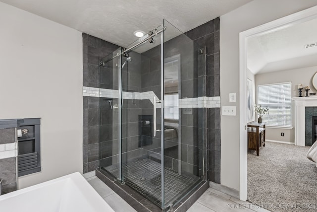 8602 S 91st E Ave, Tulsa, OK 74133 - ensuite bathroom with a high end fireplace, a bathtub, a stall shower, and tile patterned flooring