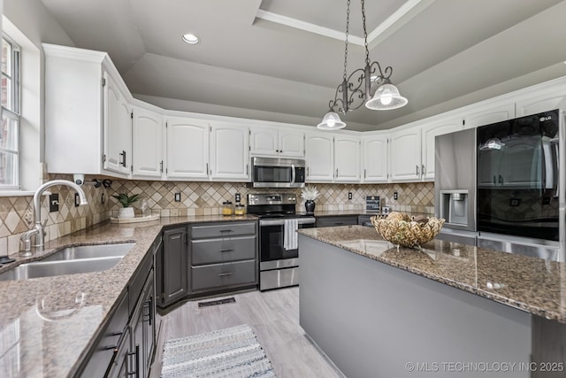 8602 S 91st E Ave, Tulsa, OK 74133 - kitchen with appliances with stainless steel finishes, a raised ceiling, stone counters, white cabinets, and recessed lighting
