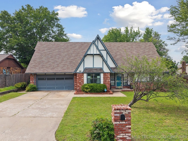 11029 E 66th St, Tulsa, OK 74133 - tudor-style house with a garage, concrete driveway, stucco siding, a shingled roof, and brick siding