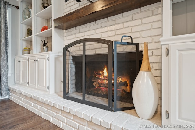 11029 E 66th St, Tulsa, OK 74133 - detailed view of a fireplace, wood finished floors, and brick wall