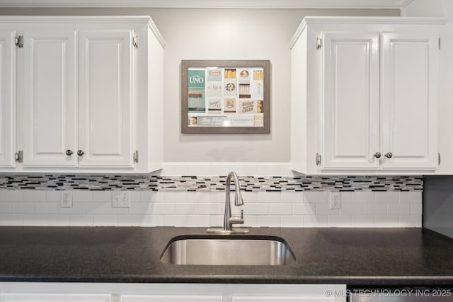 11029 E 66th St, Tulsa, OK 74133 - kitchen with dark countertops, white cabinets, and backsplash