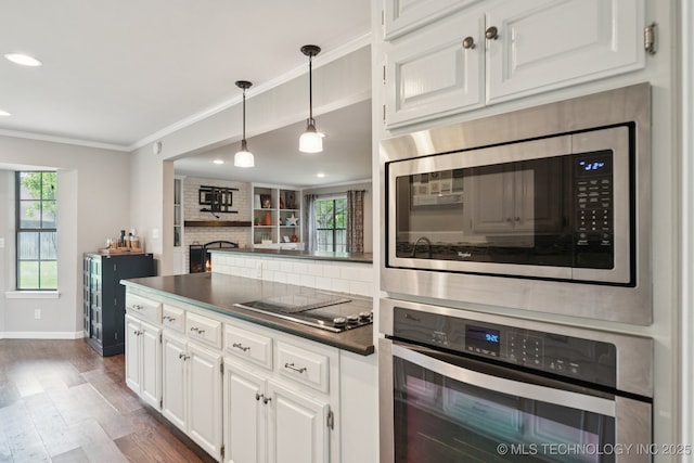 11029 E 66th St, Tulsa, OK 74133 - kitchen with stainless steel appliances, dark countertops, white cabinets, ornamental molding, and dark wood-style floors