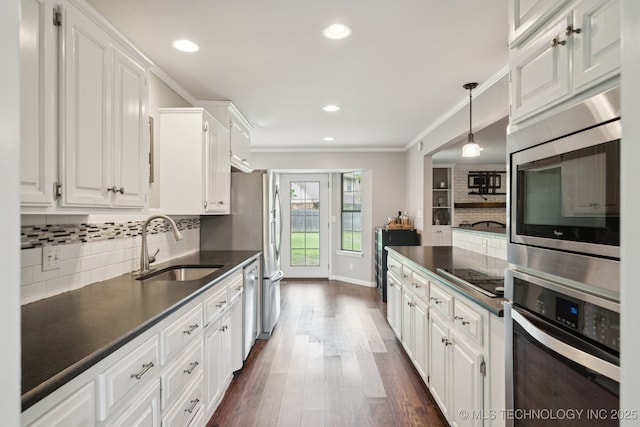 11029 E 66th St, Tulsa, OK 74133 - kitchen featuring stainless steel appliances, dark countertops, white cabinetry, decorative backsplash, and dark wood-type flooring