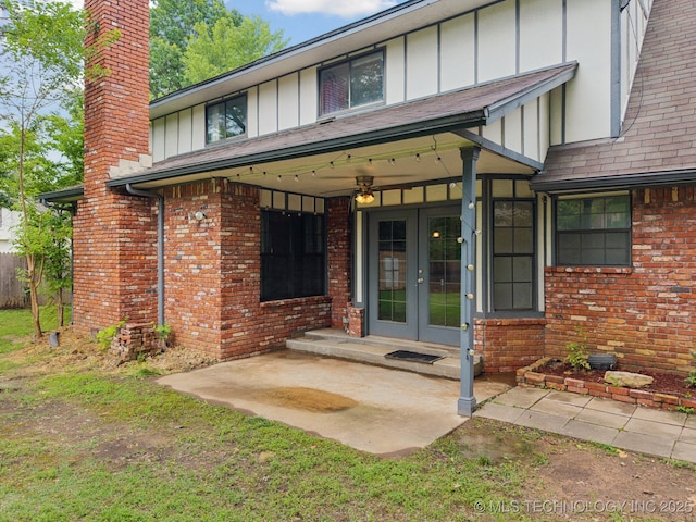 11029 E 66th St, Tulsa, OK 74133 - property entrance with board and batten siding, french doors, brick siding, and a chimney