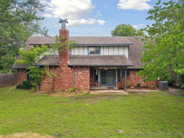 11029 E 66th St, Tulsa, OK 74133 - back of property featuring french doors, a chimney, board and batten siding, brick siding, and a patio