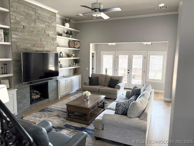 3816 E 117th Pl, Tulsa, OK 74137 - living area featuring a large fireplace, crown molding, wood finished floors, ceiling fan, and french doors