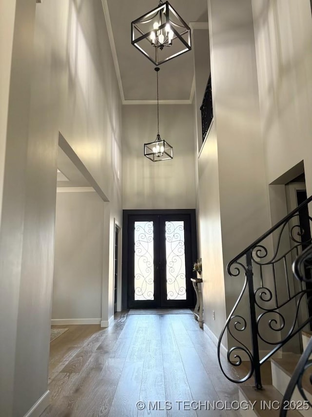 3816 E 117th Pl, Tulsa, OK 74137 - entrance foyer with a high ceiling, a chandelier, ornamental molding, hardwood / wood-style floors, and baseboards
