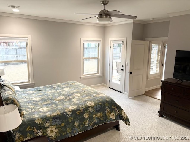3816 E 117th Pl, Tulsa, OK 74137 - bedroom featuring multiple windows, light carpet, ornamental molding, baseboards, and a ceiling fan