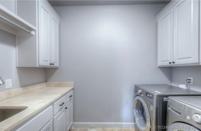 3816 E 117th Pl, Tulsa, OK 74137 - laundry room with cabinet space, independent washer and dryer, and baseboards