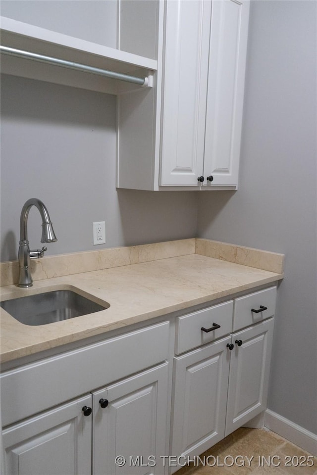 3816 E 117th Pl, Tulsa, OK 74137 - kitchen with a sink, white cabinetry, and light stone counters