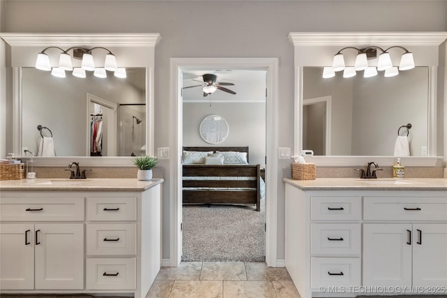 4472 S 169th E Ave, Tulsa, OK 74134 - ensuite bathroom featuring two vanities, ceiling fan, baseboards, a shower, and ornamental molding