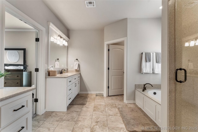 4472 S 169th E Ave, Tulsa, OK 74134 - full bathroom featuring vanity, a bath, a shower stall, and baseboards