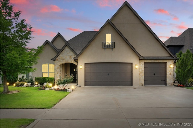 4472 S 169th E Ave, Tulsa, OK 74134 - french country style house with stone siding, driveway, stucco siding, and a yard