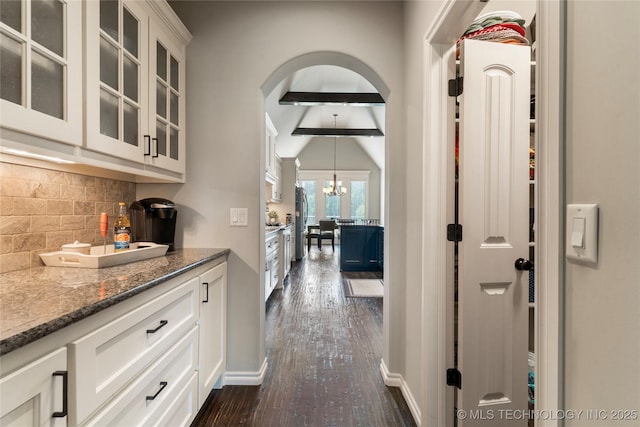 4472 S 169th E Ave, Tulsa, OK 74134 - hall with dark wood-style flooring, arched walkways, a chandelier, baseboards, and vaulted ceiling