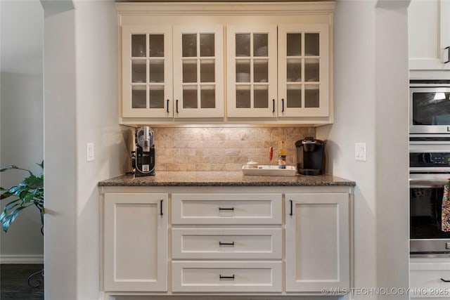 4472 S 169th E Ave, Tulsa, OK 74134 - bar area featuring stainless steel oven and tasteful backsplash