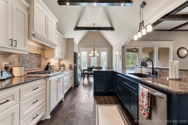 4472 S 169th E Ave, Tulsa, OK 74134 - kitchen featuring appliances with stainless steel finishes, a sink, healthy amount of natural light, and a chandelier