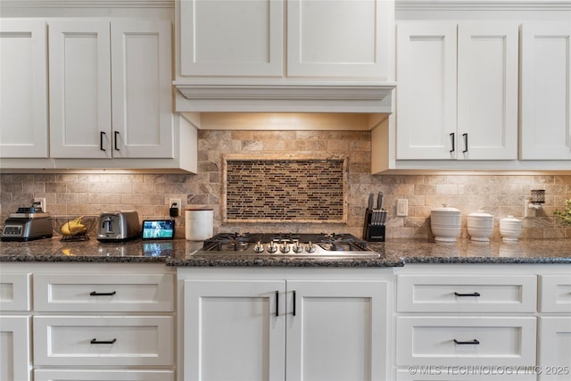 4472 S 169th E Ave, Tulsa, OK 74134 - kitchen with white cabinets, decorative backsplash, stainless steel gas cooktop, and dark stone counters