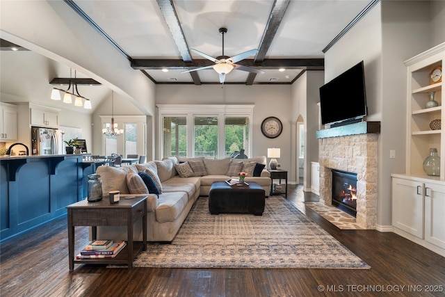 4472 S 169th E Ave, Tulsa, OK 74134 - living room with a ceiling fan, a fireplace, arched walkways, dark wood-type flooring, and beam ceiling