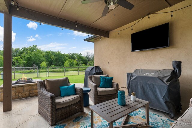 4472 S 169th E Ave, Tulsa, OK 74134 - view of patio with ceiling fan, view of wooded area, and an outdoor living space with a fire pit