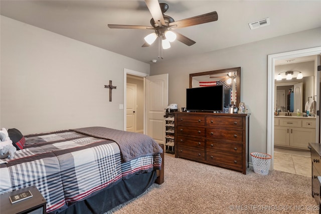 4472 S 169th E Ave, Tulsa, OK 74134 - bedroom featuring light colored carpet, connected bathroom, and ceiling fan
