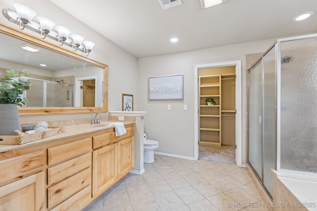 3012 W Mobile St, Broken Arrow, OK 74011 - bathroom featuring vanity, a stall shower, a walk in closet, tile patterned floors, and recessed lighting