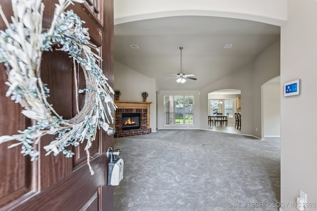 3012 W Mobile St, Broken Arrow, OK 74011 - living area with arched walkways, carpet flooring, ceiling fan, a brick fireplace, and vaulted ceiling