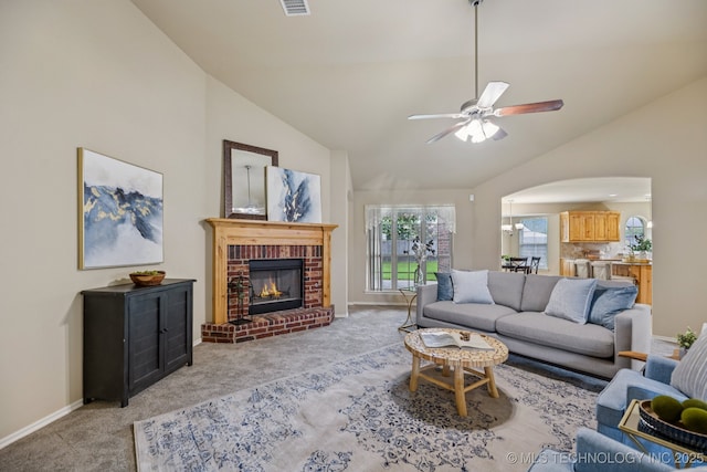 3012 W Mobile St, Broken Arrow, OK 74011 - living room featuring light colored carpet, arched walkways, a ceiling fan, a brick fireplace, and high vaulted ceiling