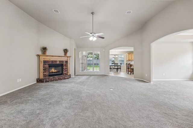 3012 W Mobile St, Broken Arrow, OK 74011 - unfurnished living room featuring arched walkways, a ceiling fan, carpet flooring, a brick fireplace, and high vaulted ceiling