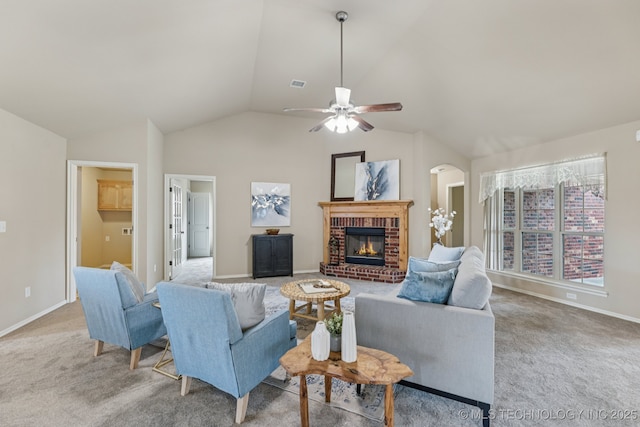 3012 W Mobile St, Broken Arrow, OK 74011 - living room featuring vaulted ceiling, carpet floors, a ceiling fan, a fireplace, and arched walkways