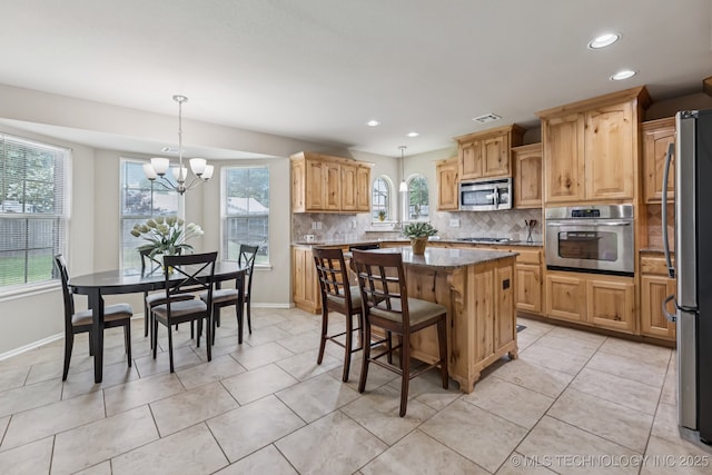 3012 W Mobile St, Broken Arrow, OK 74011 - kitchen with stainless steel appliances, decorative backsplash, recessed lighting, healthy amount of natural light, and a kitchen island